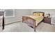 Cozy bedroom with plush carpet, complemented by a warm color palette, and natural light at 7201 Talamore Dr, Wesley Chapel, FL 33545