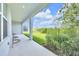 Beautiful covered patio with lush landscaping, ideal for enjoying outdoor living and dining at 7201 Talamore Dr, Wesley Chapel, FL 33545