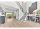 Elegant foyer featuring a staircase, modern console table, and wood flooring, with a view to the living room at 7201 Talamore Dr, Wesley Chapel, FL 33545