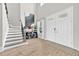 Elegant foyer featuring a staircase, double doors, modern console table, and wood flooring at 7201 Talamore Dr, Wesley Chapel, FL 33545