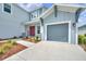 Inviting two-story home featuring a well-manicured lawn, two-car garage, and an inviting red front door at 7201 Talamore Dr, Wesley Chapel, FL 33545