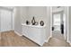 Stylish hallway featuring hardwood floors and a built-in display cabinet at 7201 Talamore Dr, Wesley Chapel, FL 33545