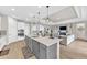 Modern kitchen with island, stainless appliances, pendant lights and open floor plan at 7201 Talamore Dr, Wesley Chapel, FL 33545