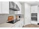 Contemporary kitchen featuring sleek appliances, ample cabinet space, and a stylish cooktop at 7201 Talamore Dr, Wesley Chapel, FL 33545