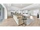 Bright, open-concept living room featuring recessed lighting and a modern, neutral-toned design scheme at 7201 Talamore Dr, Wesley Chapel, FL 33545
