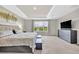 Bright main bedroom boasts a view of backyard, plush carpet, and an elegant tray ceiling at 7201 Talamore Dr, Wesley Chapel, FL 33545