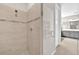 Contemporary shower featuring neutral tiling and a glass door, leading to the bathroom at 7201 Talamore Dr, Wesley Chapel, FL 33545