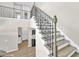 Modern staircase with wrought iron railings and hardwood floors at 7201 Talamore Dr, Wesley Chapel, FL 33545
