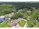 Aerial view of neighborhood with tree coverage, showcasing home at 7308 Avonwood St, Tampa, FL 33625
