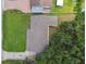 Aerial view of the home with a shingle roof and lush green lawn at 7308 Avonwood St, Tampa, FL 33625