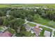 An aerial view of a neighborhood with mature trees, green lawns, and various single Gathering homes with unique roof styles at 7308 Avonwood St, Tampa, FL 33625