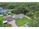 Overview of the single Gathering home with manicured lawn and mature trees at 7308 Avonwood St, Tampa, FL 33625