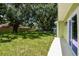 Lush backyard featuring a well-maintained lawn, and a storage shed at 7308 Avonwood St, Tampa, FL 33625