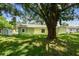 A view of the home's backyard with a large tree providing shade at 7308 Avonwood St, Tampa, FL 33625