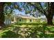 Expansive backyard with lush lawn and mature trees, providing a serene outdoor space at 7308 Avonwood St, Tampa, FL 33625