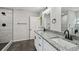 Bright bathroom featuring double vanity with granite countertops and modern black fixtures at 7308 Avonwood St, Tampa, FL 33625