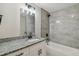 Stylish bathroom featuring granite countertops, modern black fixtures, and tiled shower at 7308 Avonwood St, Tampa, FL 33625