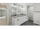 Modern bathroom with double vanity, granite countertops, dark hardware and fixtures at 7308 Avonwood St, Tampa, FL 33625