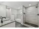 Modern bathroom featuring a walk-in shower, soaker tub, and vanity with granite countertop at 7308 Avonwood St, Tampa, FL 33625