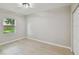 Bright bedroom with modern flooring and a window overlooking the backyard at 7308 Avonwood St, Tampa, FL 33625
