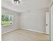 Bright bedroom with neutral paint, modern ceiling light, and large window overlooking the backyard at 7308 Avonwood St, Tampa, FL 33625