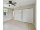 Empty bedroom offering ample closet space, light-colored walls and flooring and natural light at 7308 Avonwood St, Tampa, FL 33625