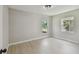 Clean, empty bedroom with natural light and light-colored walls and flooring at 7308 Avonwood St, Tampa, FL 33625