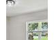 Bright bedroom with a modern ceiling light, neutral paint, and window at 7308 Avonwood St, Tampa, FL 33625