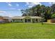 Inviting single-story home boasts a well-manicured lawn and quaint, covered front porch at 7308 Avonwood St, Tampa, FL 33625
