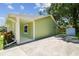 The exterior of the house showcases a well-maintained driveway and lush landscaping at 7308 Avonwood St, Tampa, FL 33625