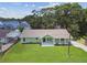 Charming single-story home with a well-manicured lawn and beautiful landscaping at 7308 Avonwood St, Tampa, FL 33625