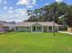 Inviting home showcasing a well-kept lawn, mature trees, and charming curb appeal at 7308 Avonwood St, Tampa, FL 33625