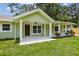 Welcoming front porch with white columns and landscaping, leading to a cozy home at 7308 Avonwood St, Tampa, FL 33625