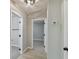 Hallway view showcasing neutral paint, modern flooring, and access to multiple rooms at 7308 Avonwood St, Tampa, FL 33625