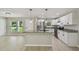 Modern kitchen with stainless steel appliances, granite counters, and an island with a breakfast bar at 7308 Avonwood St, Tampa, FL 33625