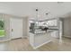 Kitchen boasts stainless steel appliances, island with breakfast bar, and granite countertops at 7308 Avonwood St, Tampa, FL 33625