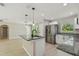 Updated kitchen features an island, stainless steel appliances, and granite countertops at 7308 Avonwood St, Tampa, FL 33625