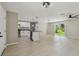 Open floor plan featuring an island kitchen with stainless steel appliances and white cabinetry at 7308 Avonwood St, Tampa, FL 33625