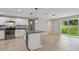 Bright kitchen displays stainless steel appliances, an island, and granite countertops at 7308 Avonwood St, Tampa, FL 33625