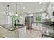 Updated kitchen features an island, stainless steel appliances, and granite countertops at 7308 Avonwood St, Tampa, FL 33625