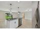 Modern kitchen with granite island, stainless dishwasher, and open layout to the living area at 7308 Avonwood St, Tampa, FL 33625
