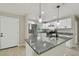 This modern kitchen boasts stainless steel appliances, granite countertops, and stylish pendant lighting at 7308 Avonwood St, Tampa, FL 33625