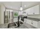 Updated kitchen displays stainless steel appliances, granite countertops, and stylish lighting at 7308 Avonwood St, Tampa, FL 33625