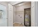 Efficient laundry area featuring a water heater and ample shelving for storage solutions at 7308 Avonwood St, Tampa, FL 33625