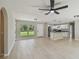 Bright living room showcases wood-look floors and an open layout to the modern kitchen at 7308 Avonwood St, Tampa, FL 33625