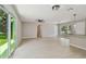 Bright, spacious living room with sliding doors, fan, and view of the kitchen island at 7308 Avonwood St, Tampa, FL 33625