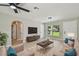 Bright living room with neutral decor, contemporary furnishings, and an archway to the next room at 7308 Avonwood St, Tampa, FL 33625