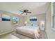 Cozy main bedroom features ceiling fan, large bed, and neutral decor at 7308 Avonwood St, Tampa, FL 33625