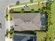 Aerial view of a well-maintained home featuring a screened-in pool and lush green landscaping at 7520 Paradiso Dr, Apollo Beach, FL 33572