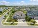 Aerial view of a single-Gathering home in a peaceful residential neighborhood with manicured lawns and mature trees at 7520 Paradiso Dr, Apollo Beach, FL 33572